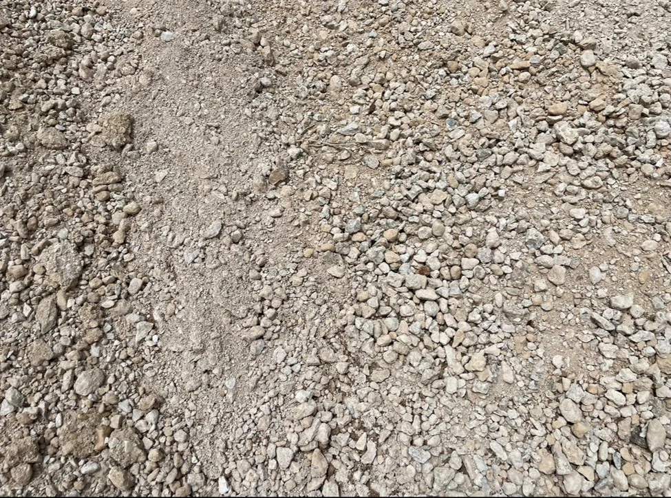 Closeup of crushed concrete base particles and fines.