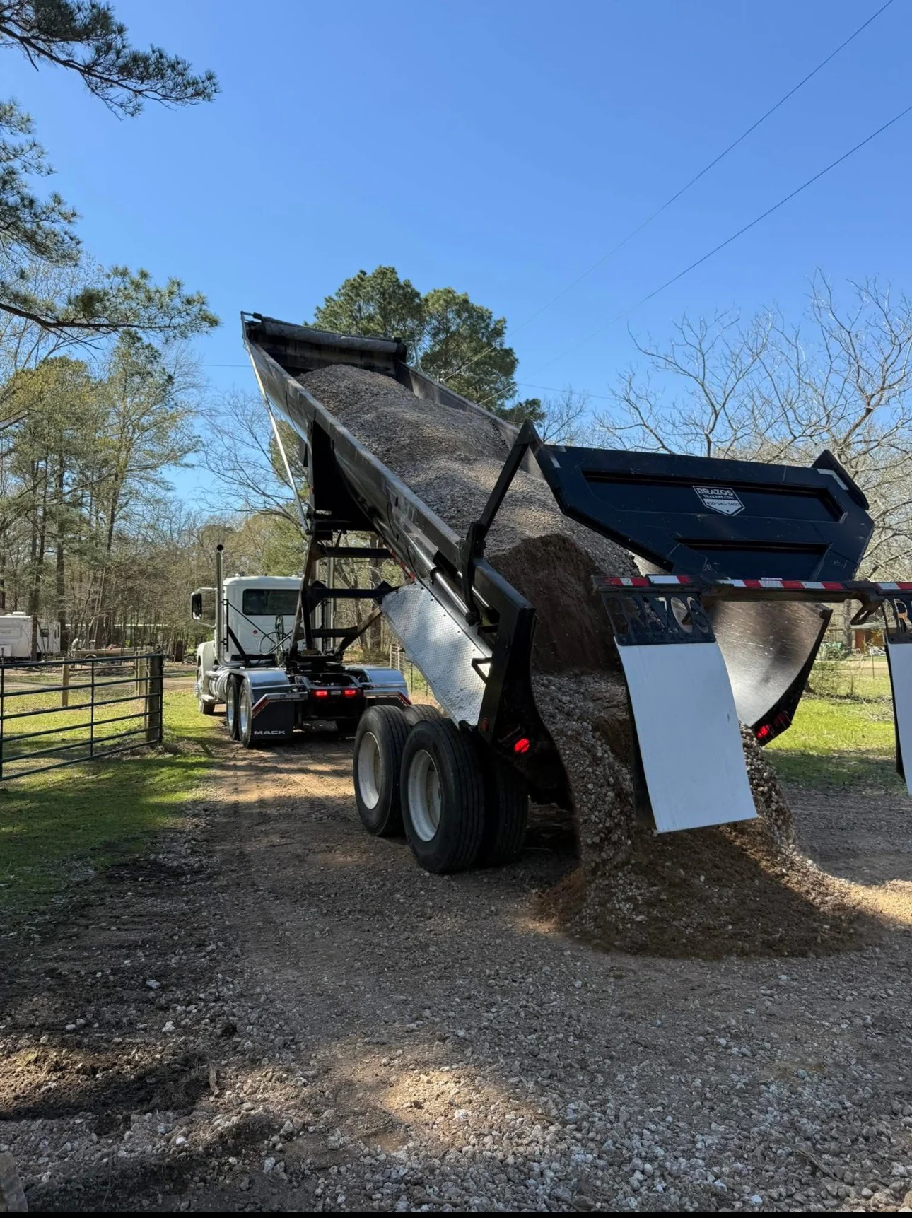Dump truck delivering aggregate to a project.