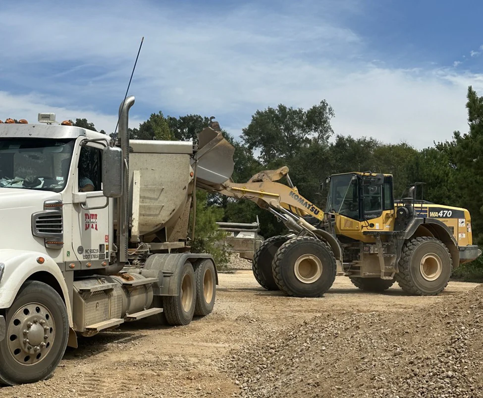Wheel loader loading a truck with material.